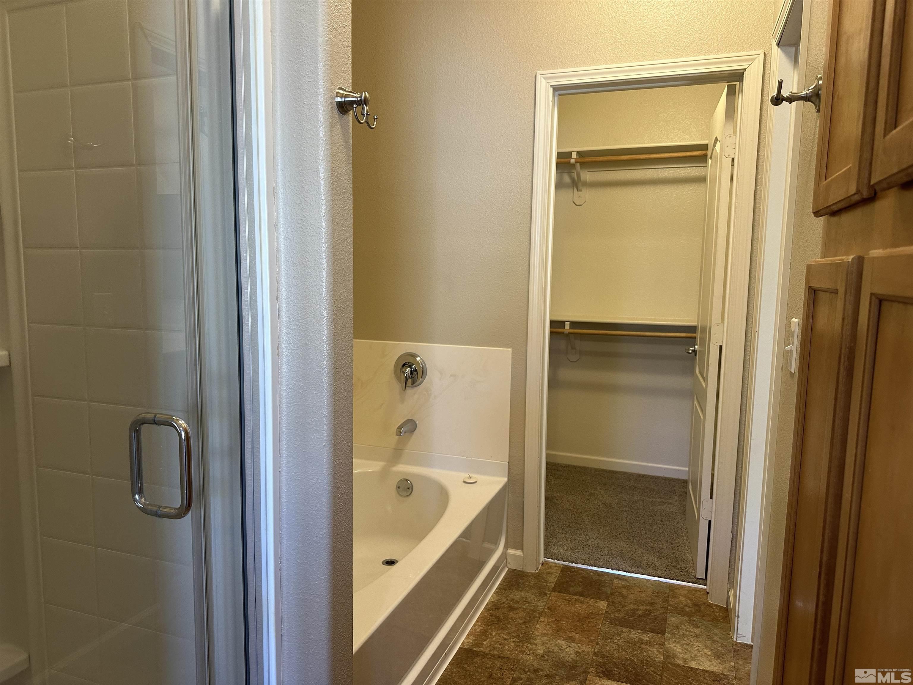 9050 Double R Boulevard, Unit 422 Reno, NV 89521 - Photo 17 of 33 a bathroom with a tub and a shower