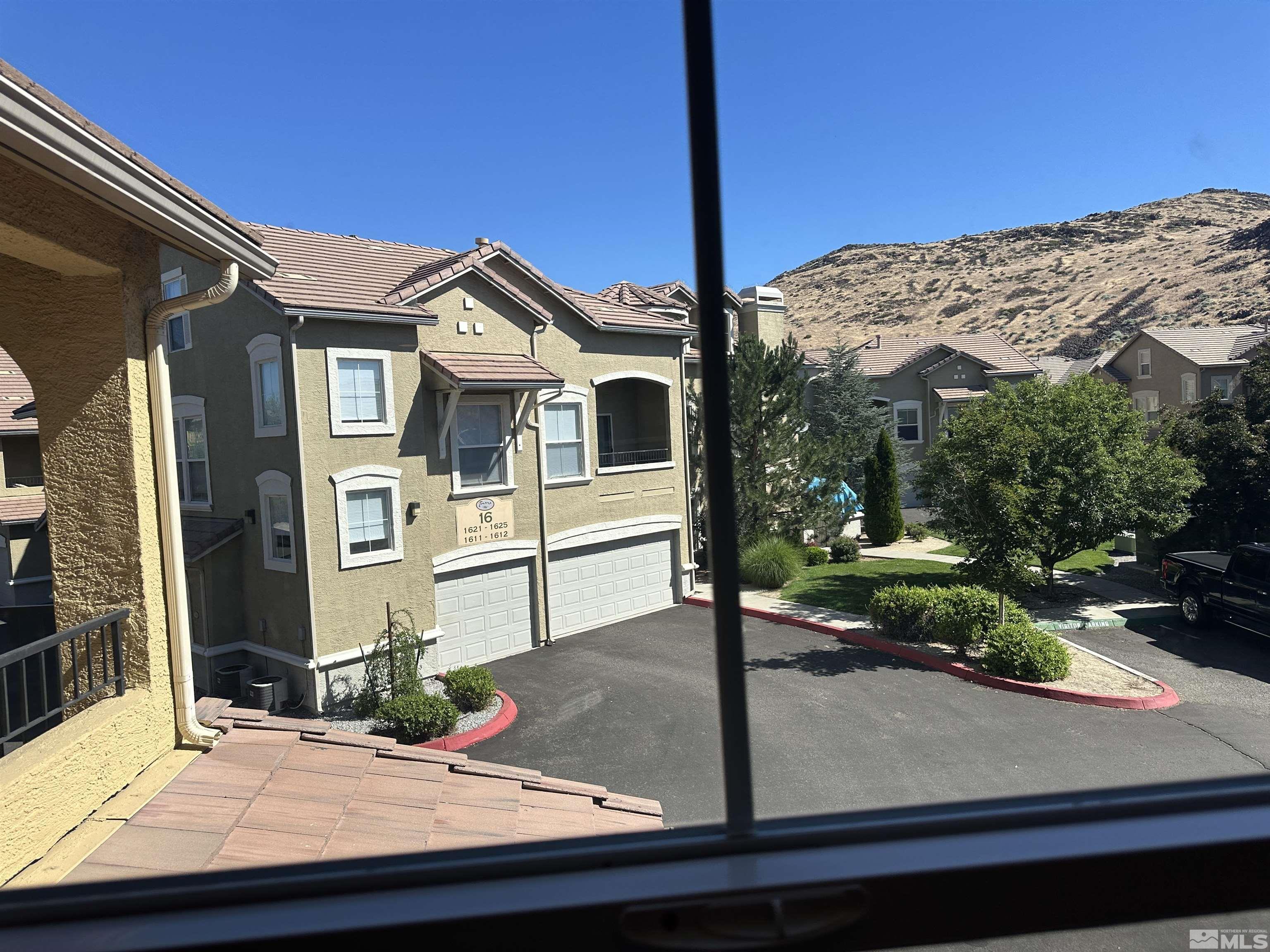 9050 Double R Boulevard, Unit 422 Reno, NV 89521 - Photo 25 of 33 a front view of a house with a mountain view