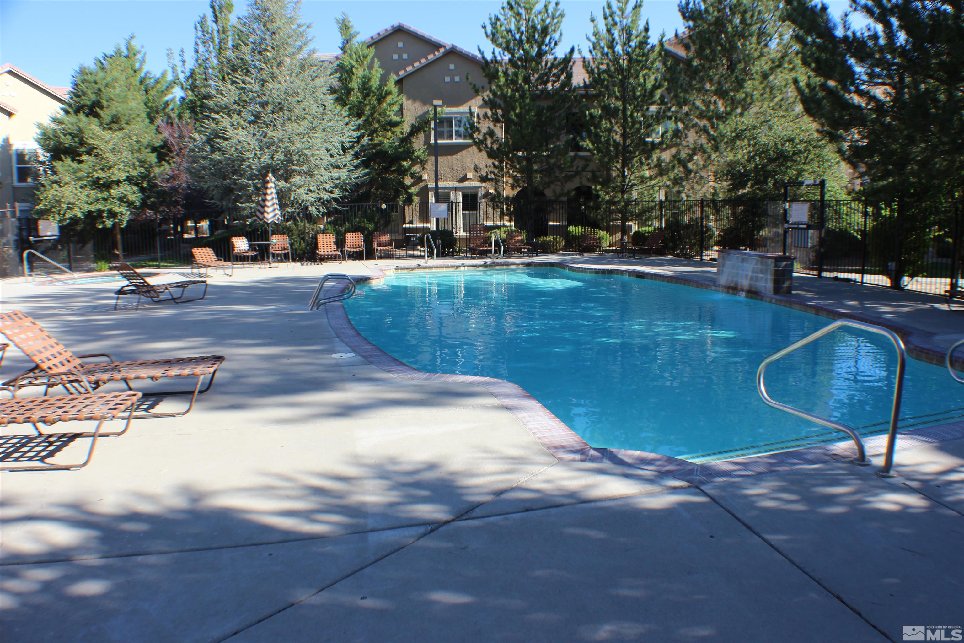 9050 Double R Boulevard, Unit 422 Reno, NV 89521 - Photo 29 of 33 a view of a swimming pool with a patio