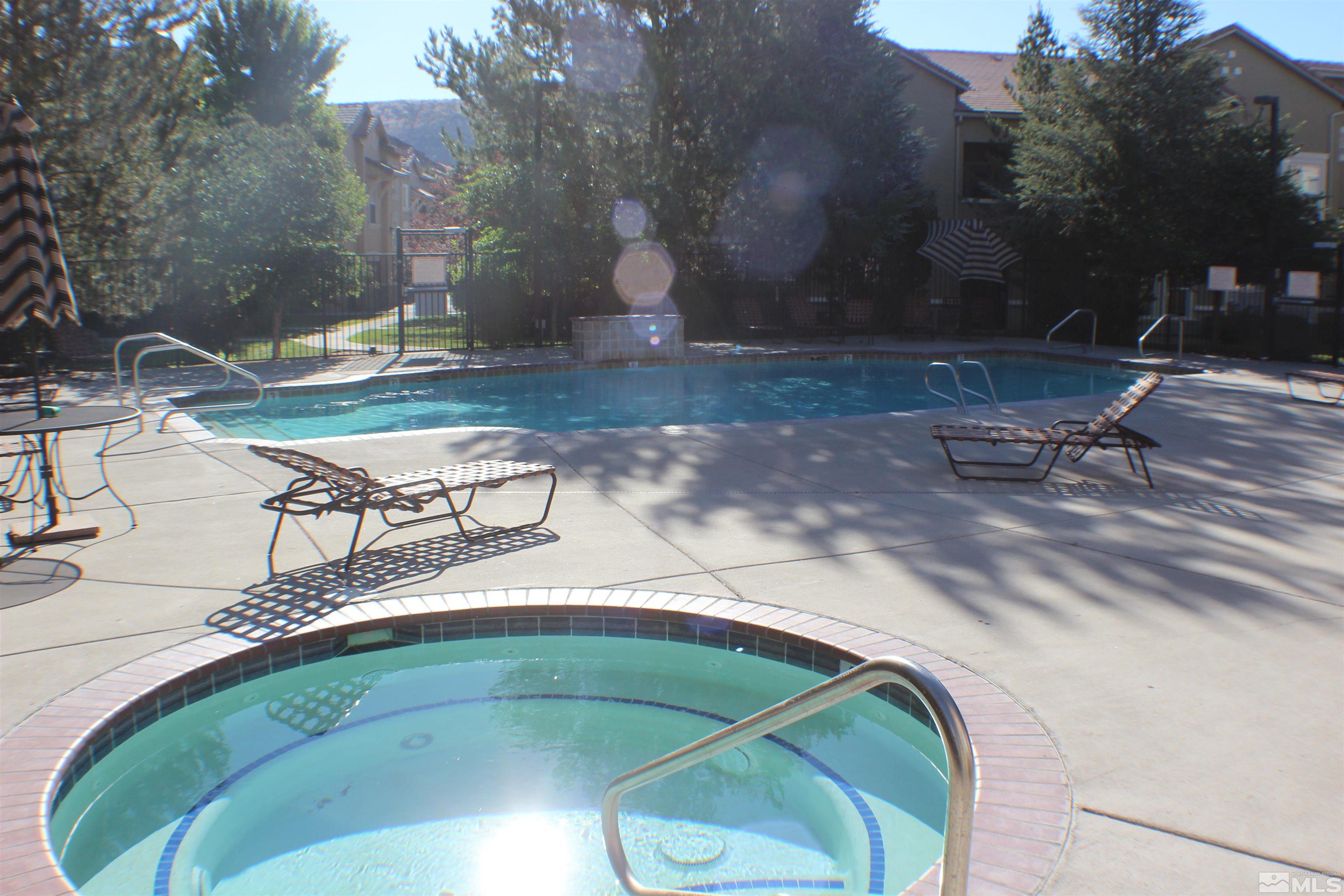 9050 Double R Boulevard, Unit 422 Reno, NV 89521 - Photo 30 of 33 a view of a swimming pool with a yard