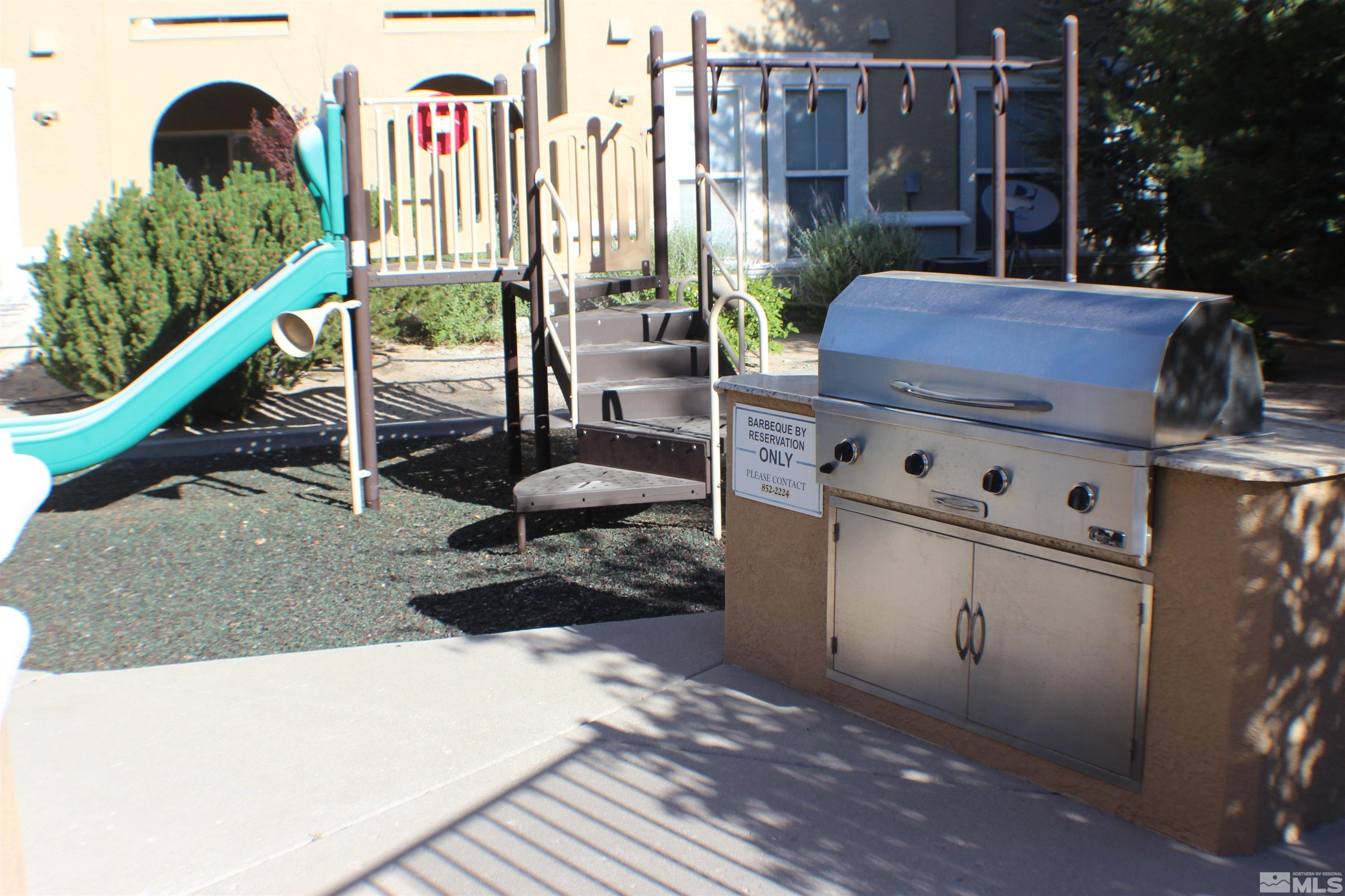 9050 Double R Boulevard, Unit 422 Reno, NV 89521 - Photo 32 of 33 a view of a chairs and table in the back yard of the house