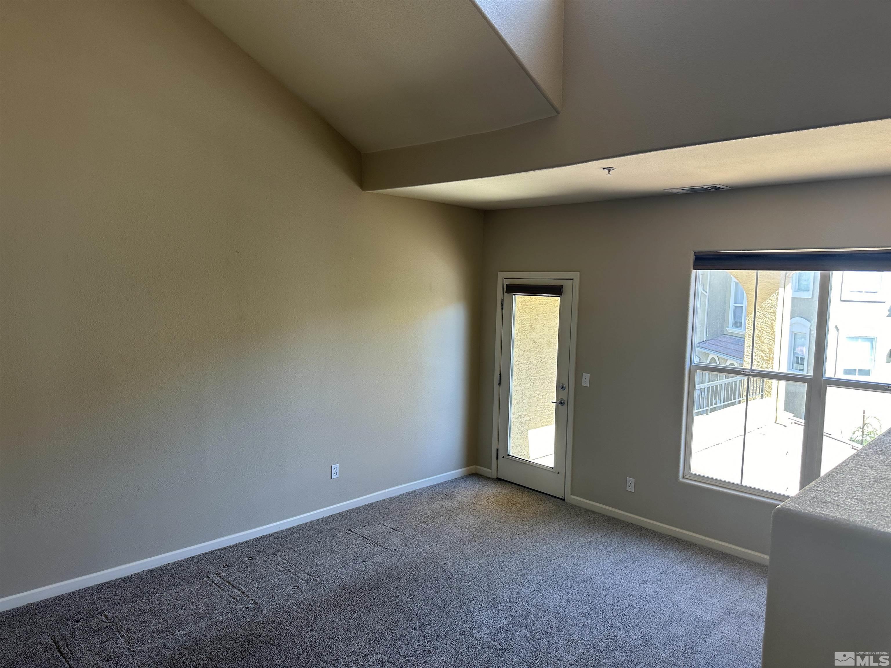 9050 Double R Boulevard, Unit 422 Reno, NV 89521 - Photo 4 of 33 an empty room with windows