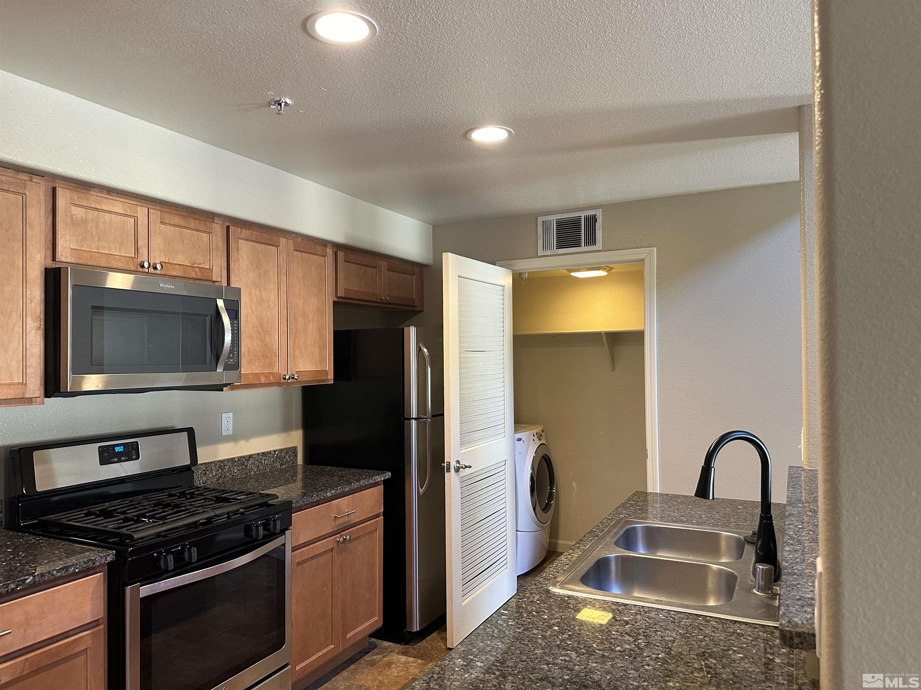 9050 Double R Boulevard, Unit 422 Reno, NV 89521 - Photo 10 of 33 a kitchen that has a sink and stainless steel appliances
