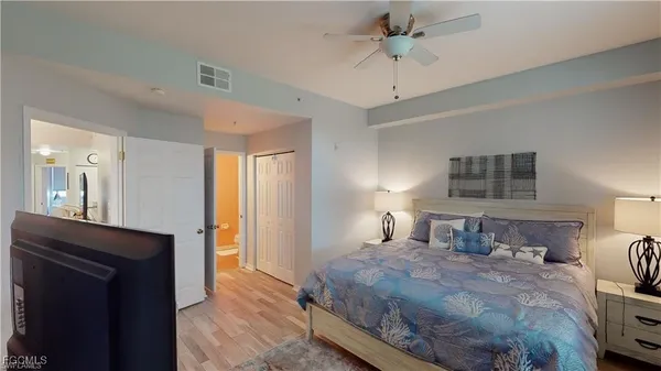 a bedroom with a bed and a chandelier