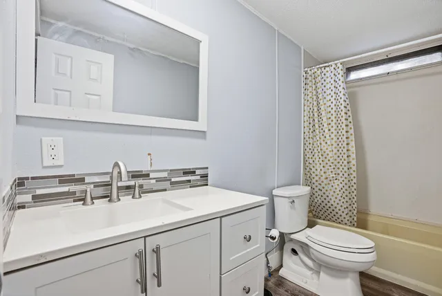 a backyard of a house with wooden floor and fence