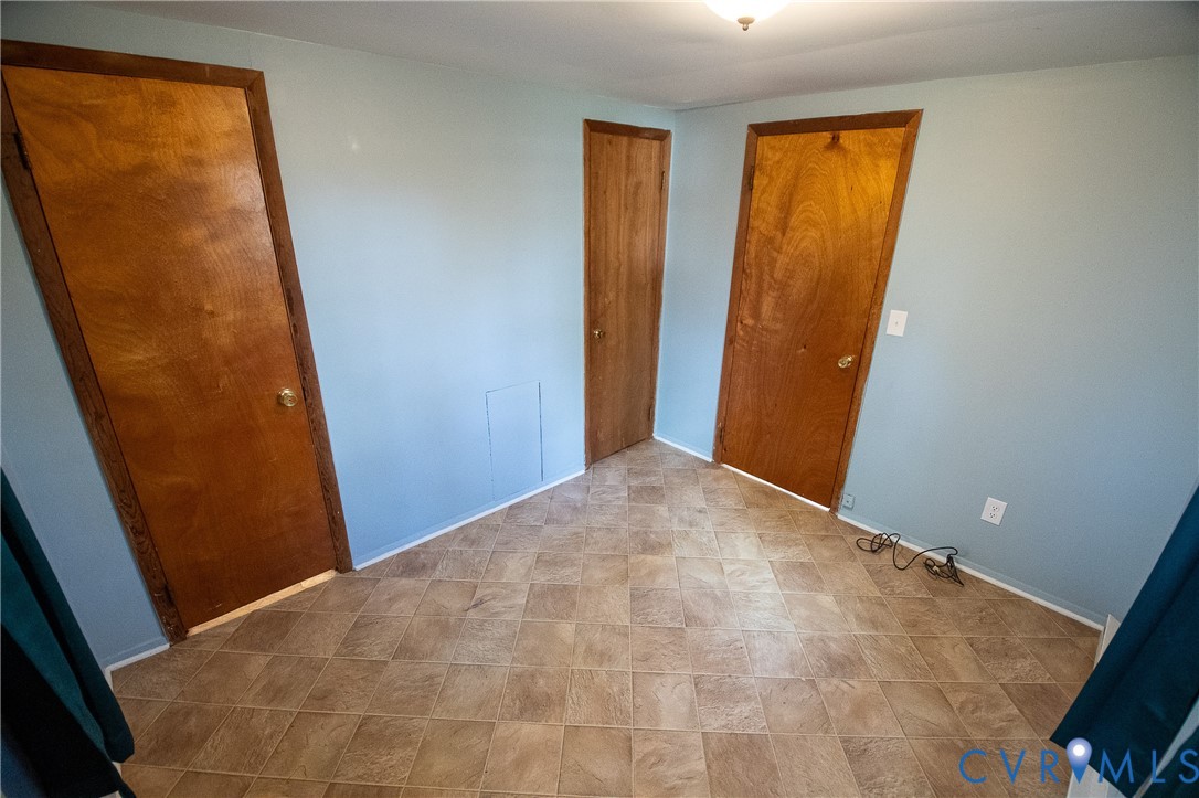 11750 Bevils Bridge Road Amelia Court House, VA 23002 - Photo 11 of 15 Unfurnished bedroom featuring baseboards and a clo