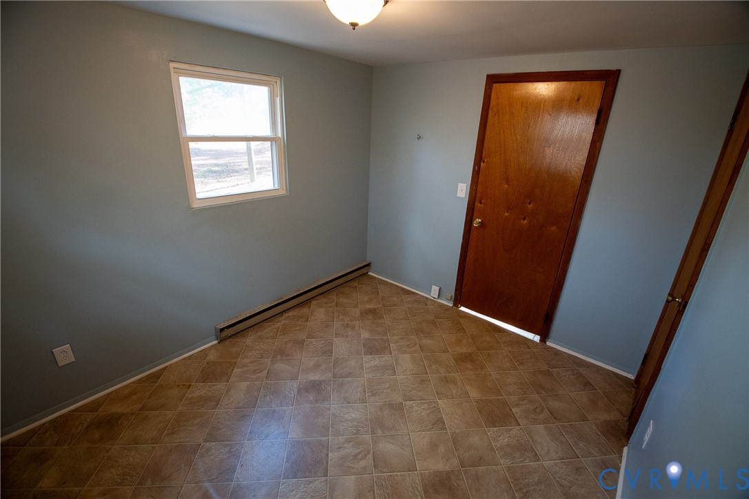 11750 Bevils Bridge Road Amelia Court House, VA 23002 - Photo 14 of 15 Unfurnished bedroom with baseboard heating and a c