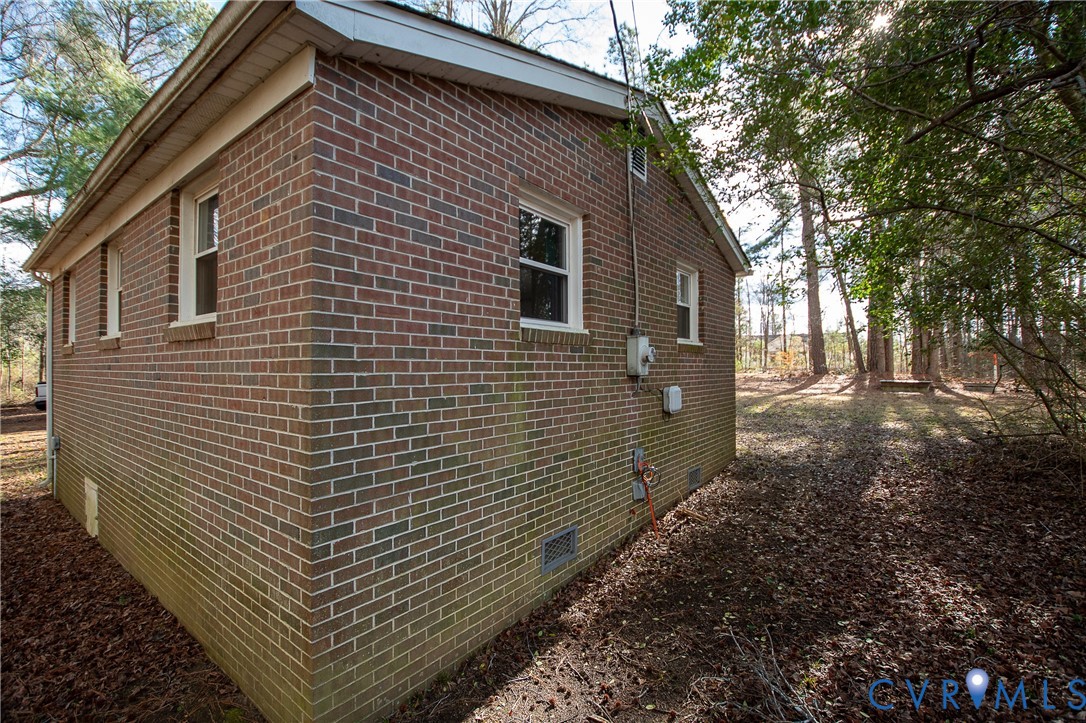 11750 Bevils Bridge Road Amelia Court House, VA 23002 - Photo 2 of 15 View of home's exterior with crawl space and brick