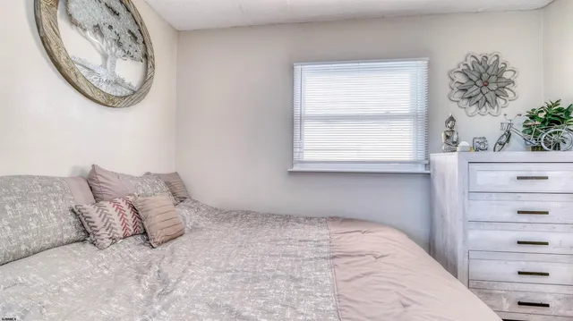 a large bed sitting in a bedroom next to a window