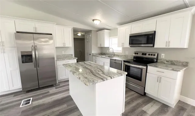 a kitchen with a sink stove and refrigerator