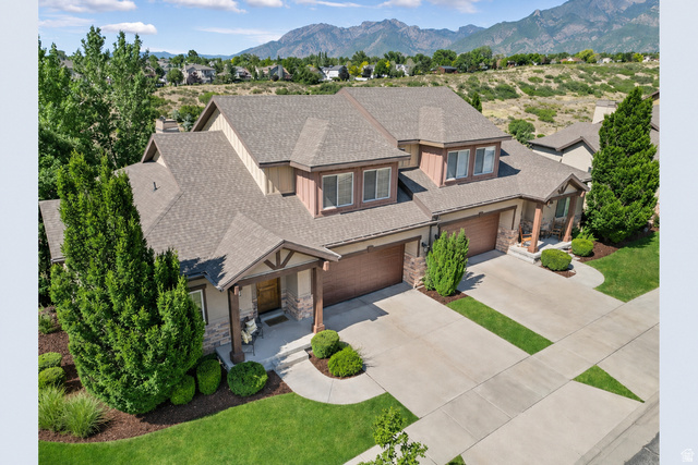 Expansive two-story residence with multiple gables and a neutral-toned roof