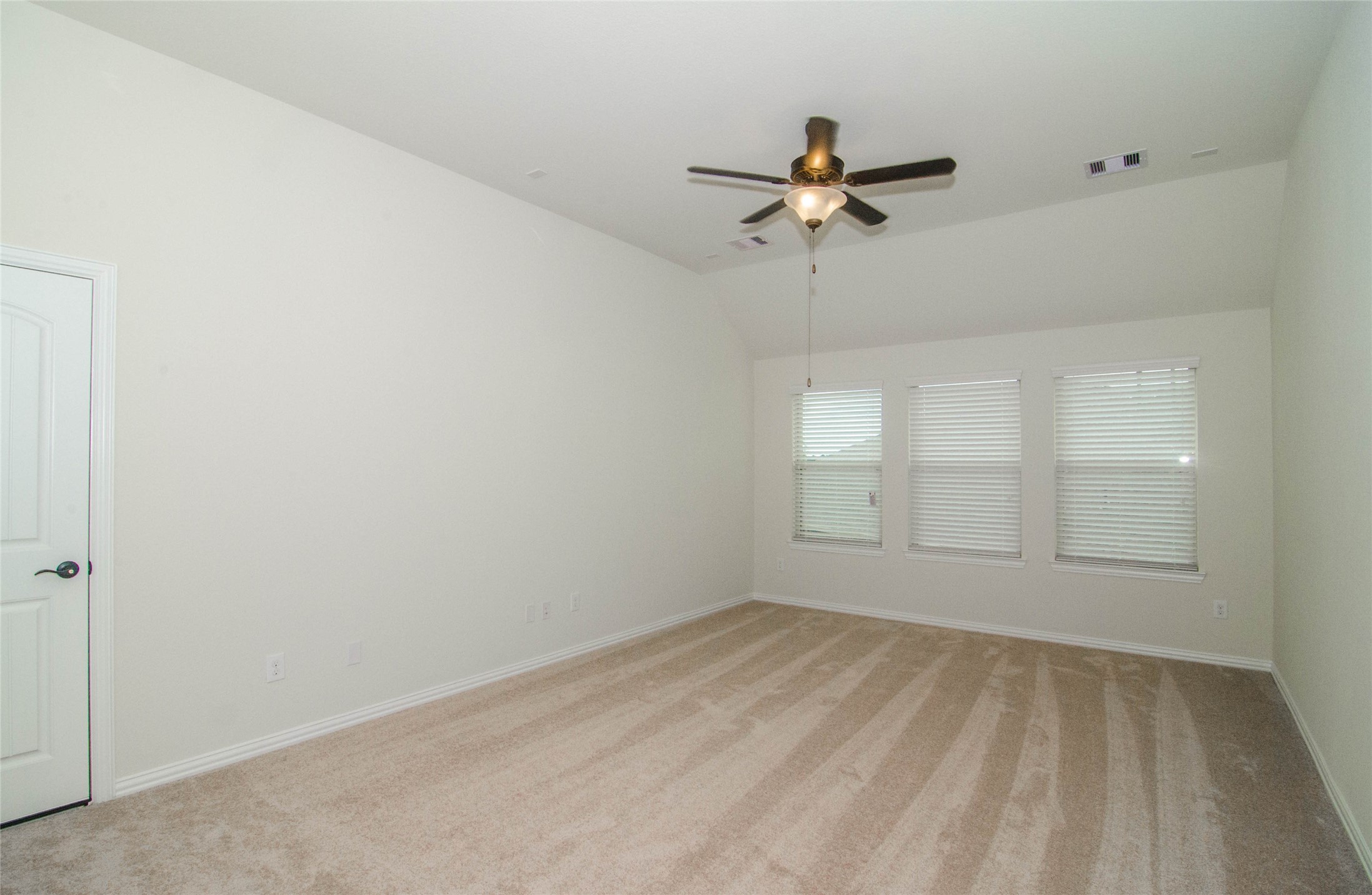18403 Weeping Spring Drive Cypress, TX 77429 - Photo 13 of 25 an empty room with windows and fan
