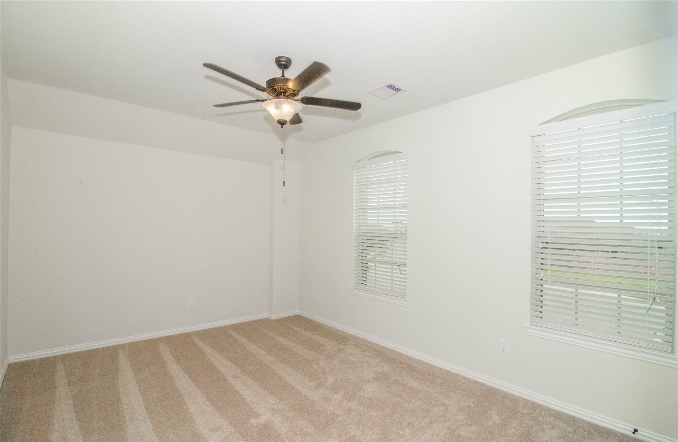 18403 Weeping Spring Drive Cypress, TX 77429 - Photo 15 of 25 an empty room with windows and fan