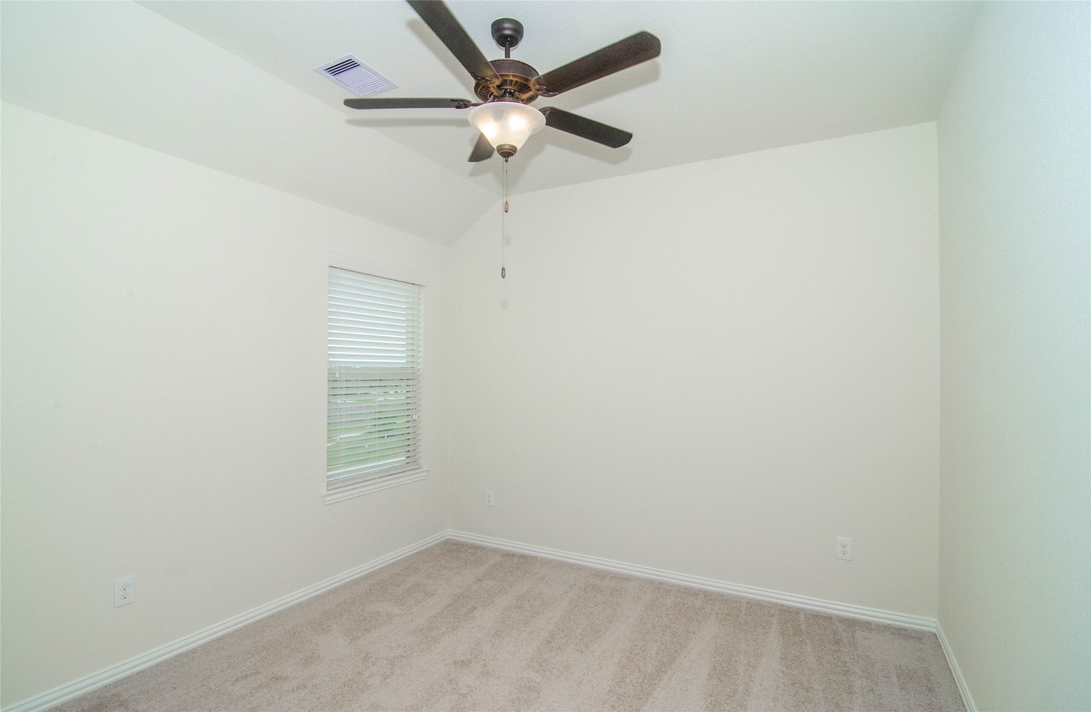 18403 Weeping Spring Drive Cypress, TX 77429 - Photo 16 of 25 an empty room with a window and a fan
