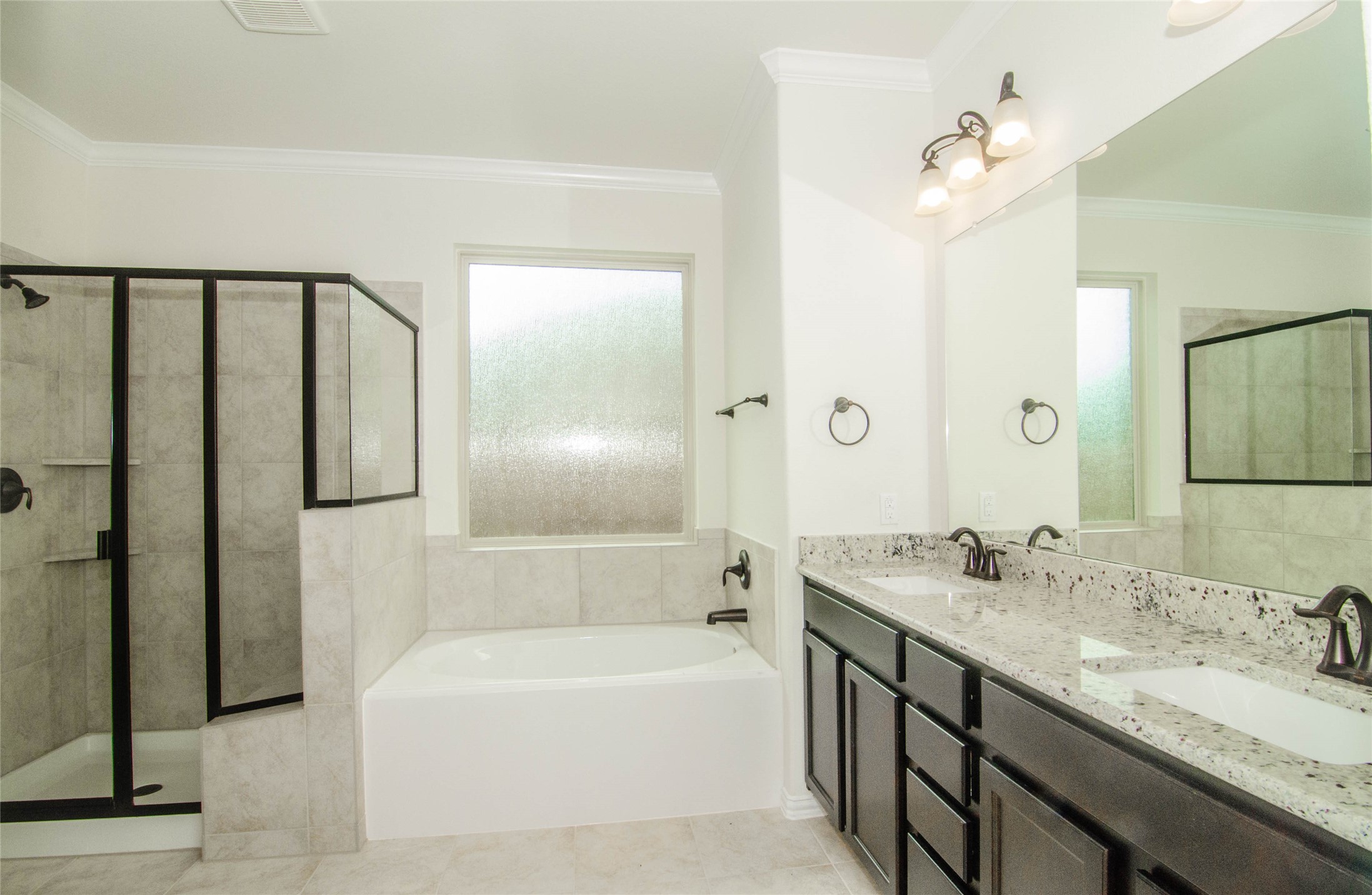 18403 Weeping Spring Drive Cypress, TX 77429 - Photo 17 of 25 a bathroom with a tub sink shower and two mirror