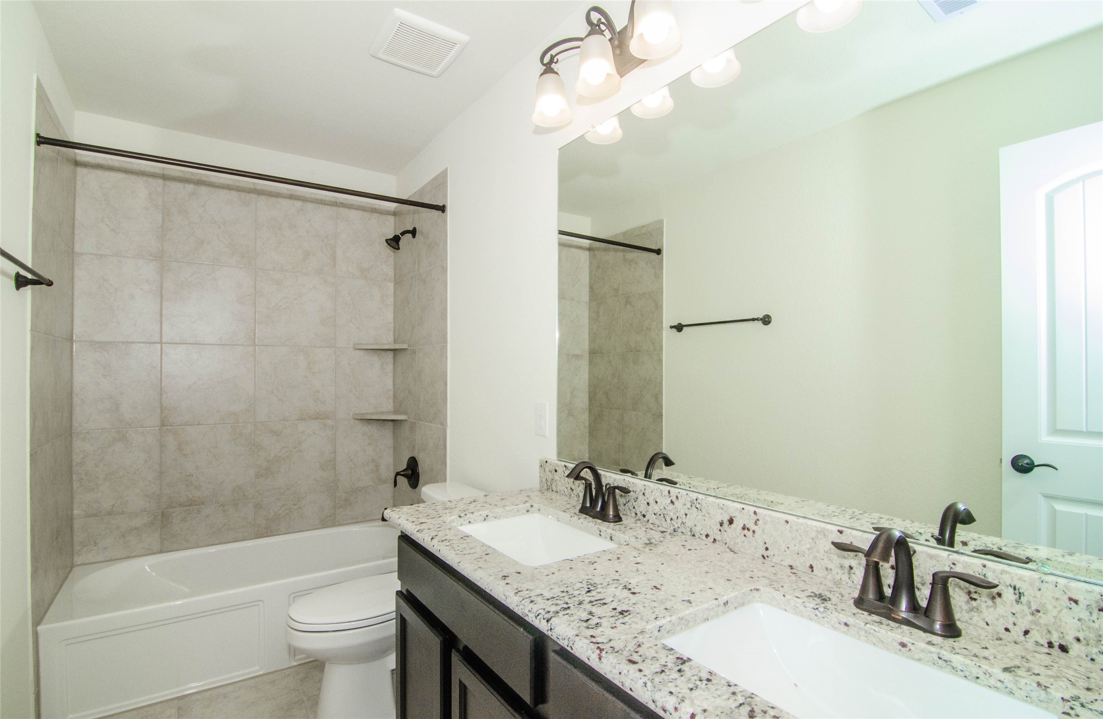 18403 Weeping Spring Drive Cypress, TX 77429 - Photo 18 of 25 a bathroom with a granite countertop sink a toilet and shower