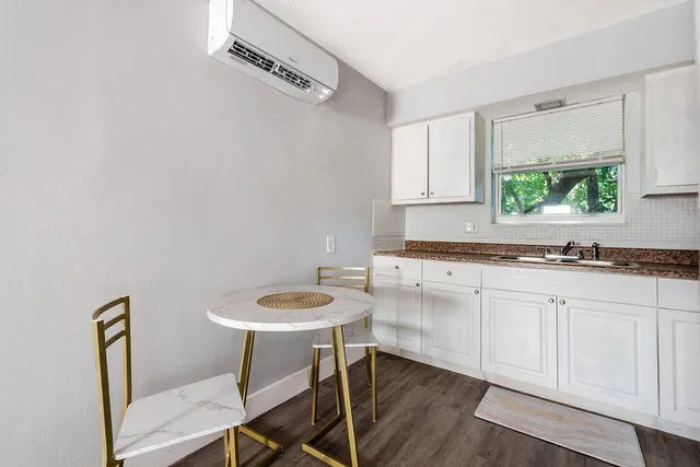 a kitchen with a sink cabinets and wooden floor