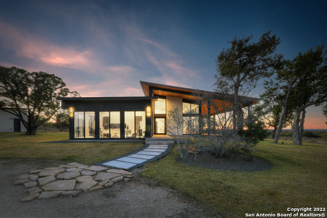 417 Southwick Ranch Johnson City, TX 78636 - Photo 1 of 45 a backyard of a house with lots of green space and fountain
