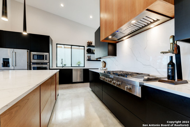417 Southwick Ranch Johnson City, TX 78636 - Photo 11 of 45 a kitchen with stainless steel appliances granite countertop a stove a sink and a refrigerator
