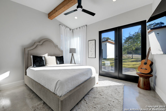 417 Southwick Ranch Johnson City, TX 78636 - Photo 20 of 45 a bedroom with a large bed and a window