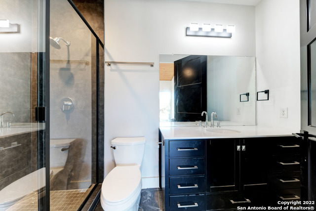 417 Southwick Ranch Johnson City, TX 78636 - Photo 23 of 45 a bathroom with a toilet a sink and mirror