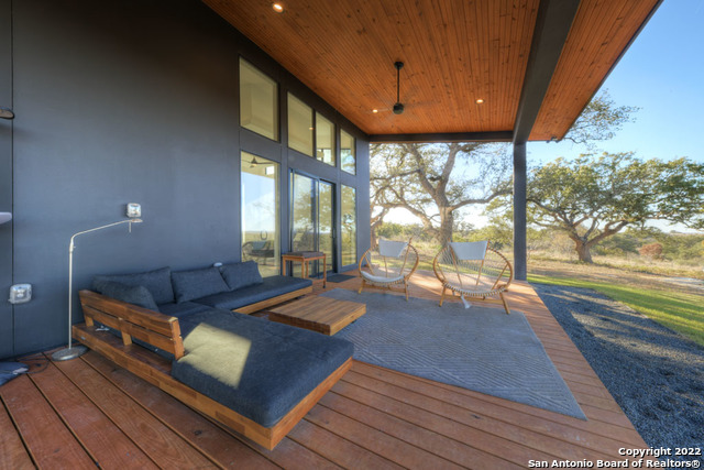 417 Southwick Ranch Johnson City, TX 78636 - Photo 28 of 45 a living room with furniture a rug and a large window