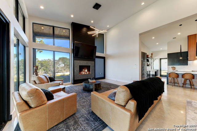 417 Southwick Ranch Johnson City, TX 78636 - Photo 6 of 45 a living room with furniture fireplace and a flat screen tv