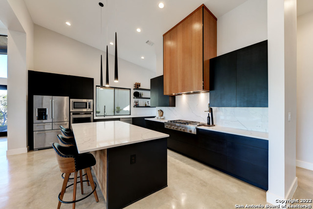 417 Southwick Ranch Johnson City, TX 78636 - Photo 10 of 45 a kitchen with stainless steel appliances a sink stove and refrigerator