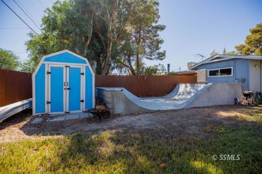 246 Peg Street Ridgecrest, CA 93555 - Photo 29 of 30 a view of a barn in the middle of a yard