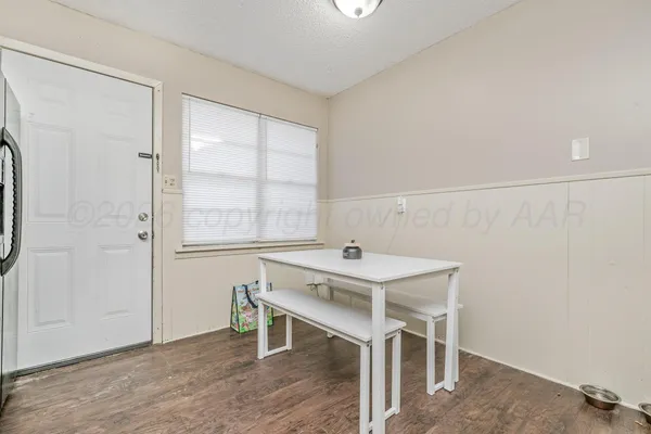 a view of a room that has a table and chairs in it