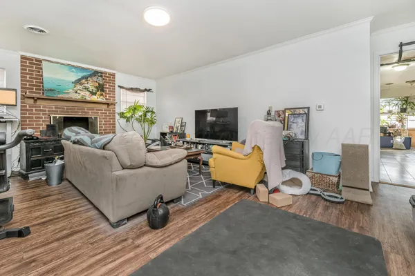 a living room with furniture a fireplace and a flat screen tv