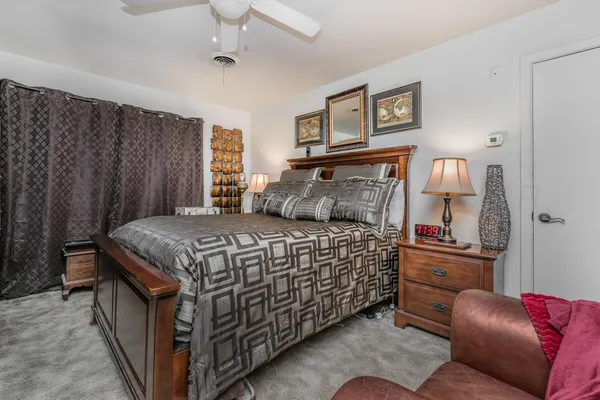 a bedroom with a bed window and couch