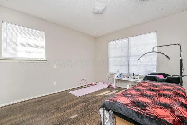 a bedroom with a bed and a large window