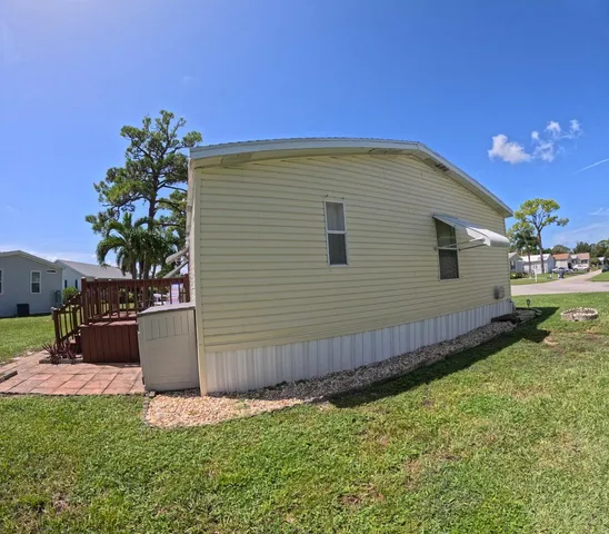 a view of a backyard with plants and a fence
