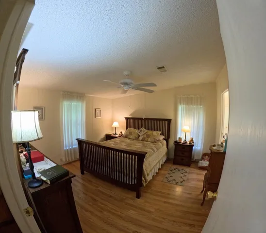 a bedroom with bed and window