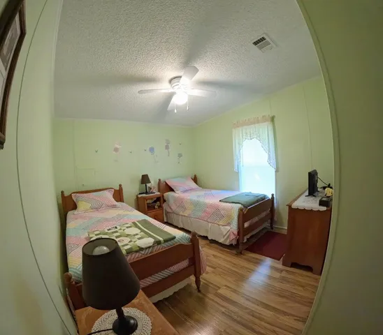 a bedroom with two beds and a lamp