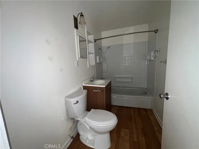 a white toilet sitting next to a bathroom sink