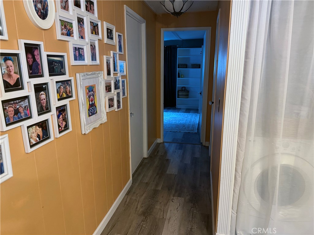 3909 Reche Road, Unit 112 Fallbrook, CA 92028 - Photo 17 of 22 a view of a hallway with wooden floor and entryway