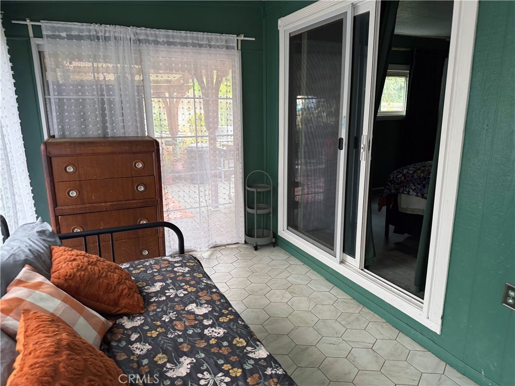 3909 Reche Road, Unit 112 Fallbrook, CA 92028 - Photo 22 of 22 a bedroom with a bed and a mirror