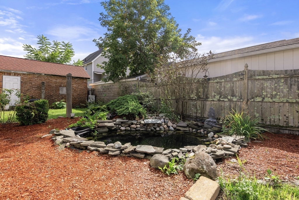 356 East Street, Unit 356 Ludlow, MA 01056 - Photo 11 of 12 a backyard of a house with a large tree