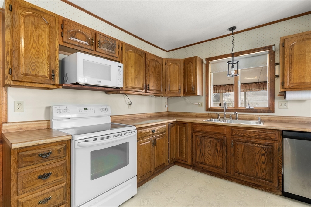 356 East Street, Unit 356 Ludlow, MA 01056 - Photo 4 of 12 a kitchen with a stove sink and cabinets