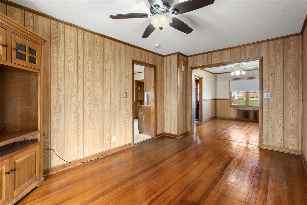 356 East Street, Unit 356 Ludlow, MA 01056 - Photo 7 of 12 a view of a hallway with wooden floor and cabinet with a flat screen tv
