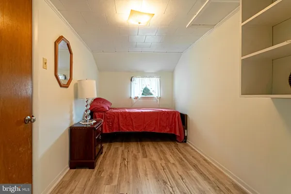 a bedroom with a bed and a mirror