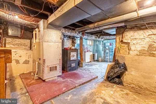 a bed sitting in a room next to a window