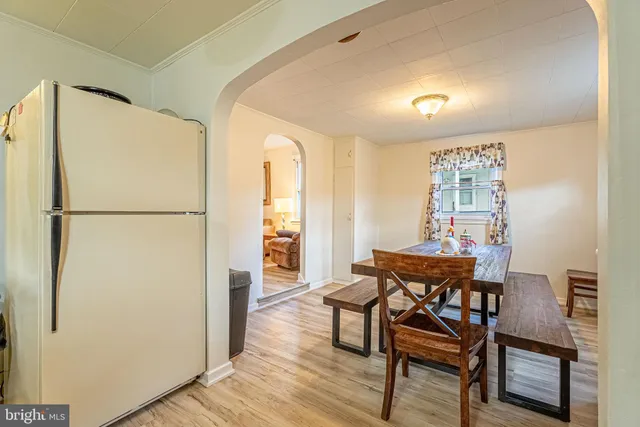 a dining room with furniture and a window