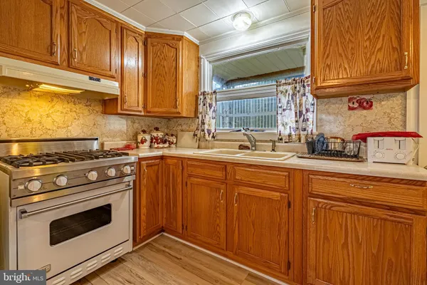 a kitchen with stainless steel appliances granite countertop a sink stove and cabinets