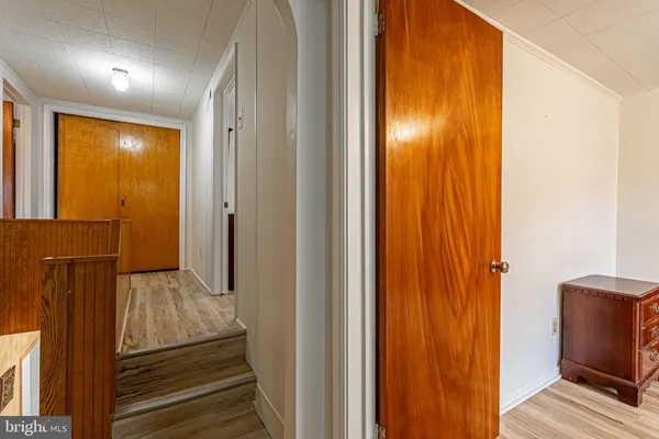 a view of a hallway with wooden floor and staircase