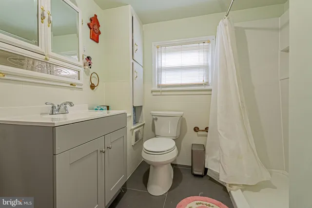 a bathroom with a sink toilet and a mirror