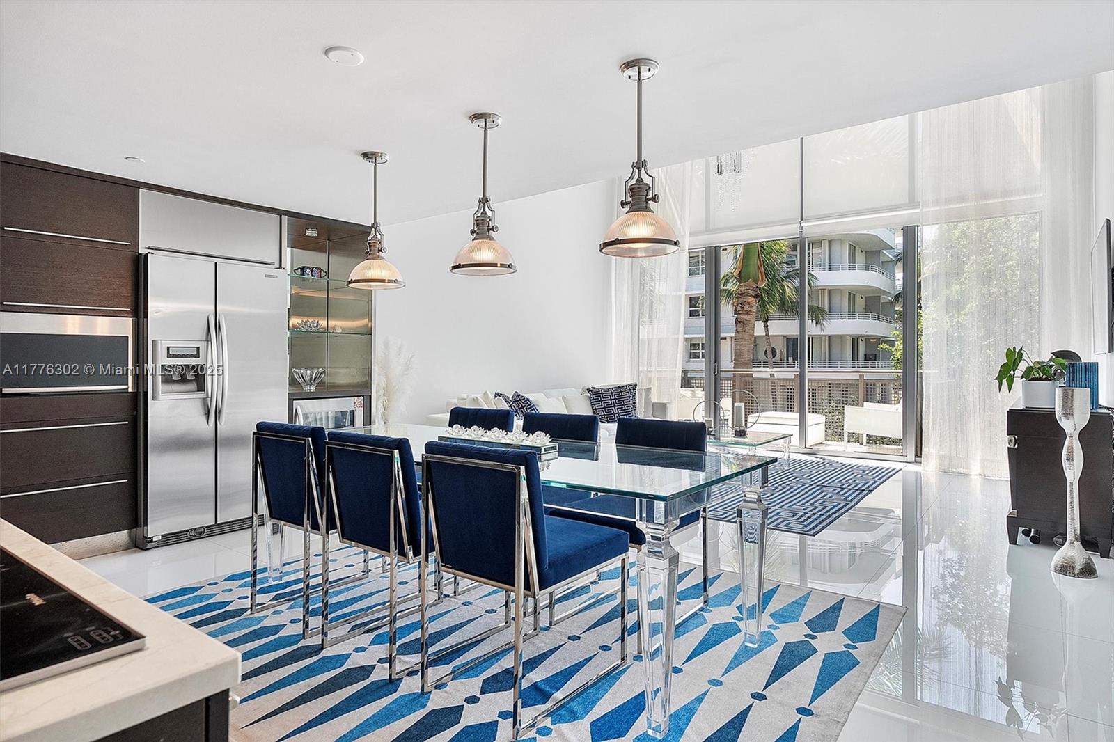 6000 Collins Avenue, Unit 326 Miami Beach, FL 33140 - Photo 11 of 45 a view of a dining room with furniture window and wooden floor