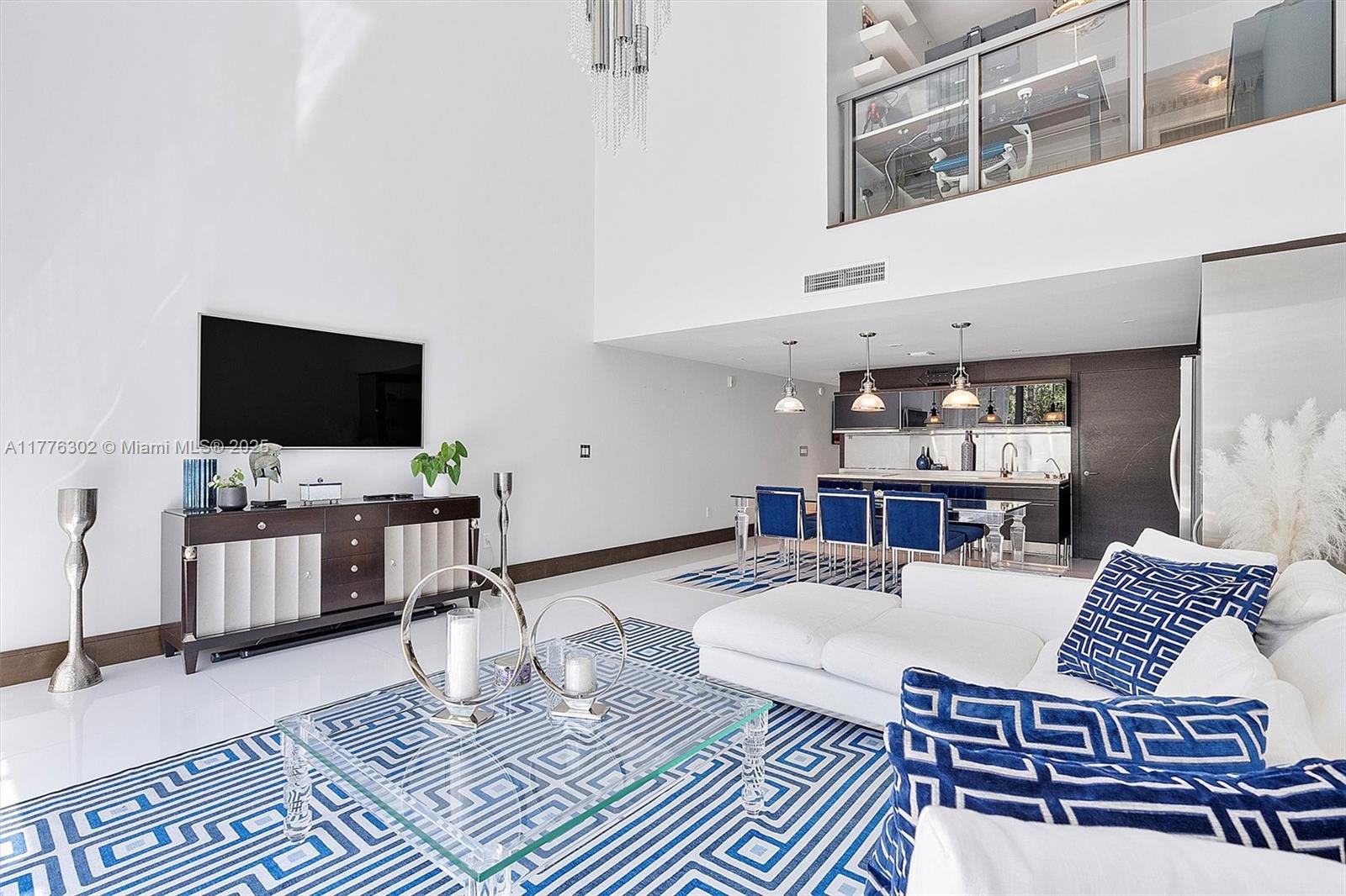 6000 Collins Avenue, Unit 326 Miami Beach, FL 33140 - Photo 2 of 45 a living room with furniture and a flat screen tv